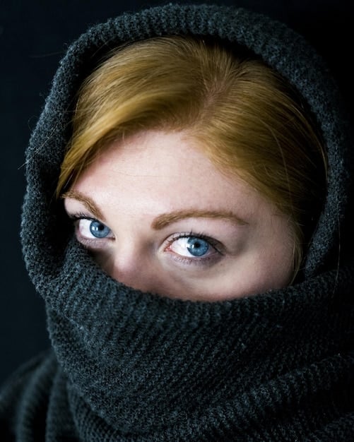A close-up shot of a detective's face in a Nordic Noir series. The detective's eyes show a mix of determination and exhaustion, and their face is weathered and lined. The background is blurred, emphasizing the detective's internal struggles and focus on the case.