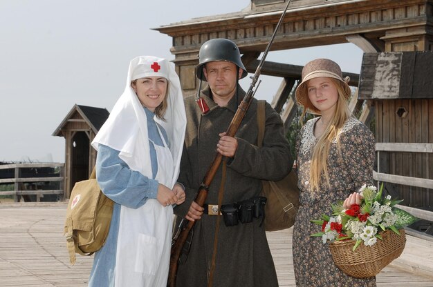 A group of tourists dressed in period costumes participating in a themed tour at a historical site.