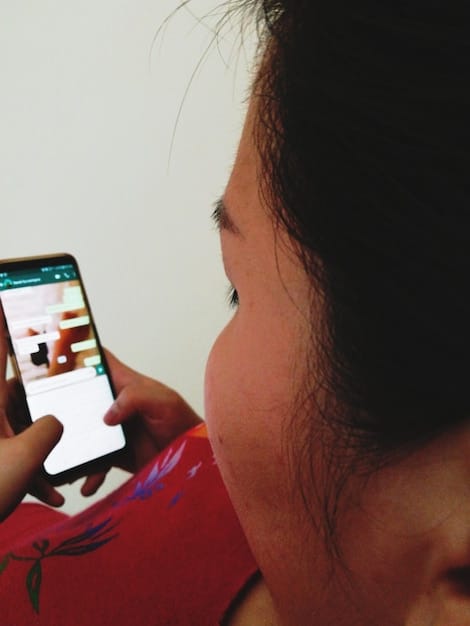 A close up of a smartphone screen showing a tweet about a teen drama, with comments and likes visible, highlighting the social media engagement surrounding these shows.